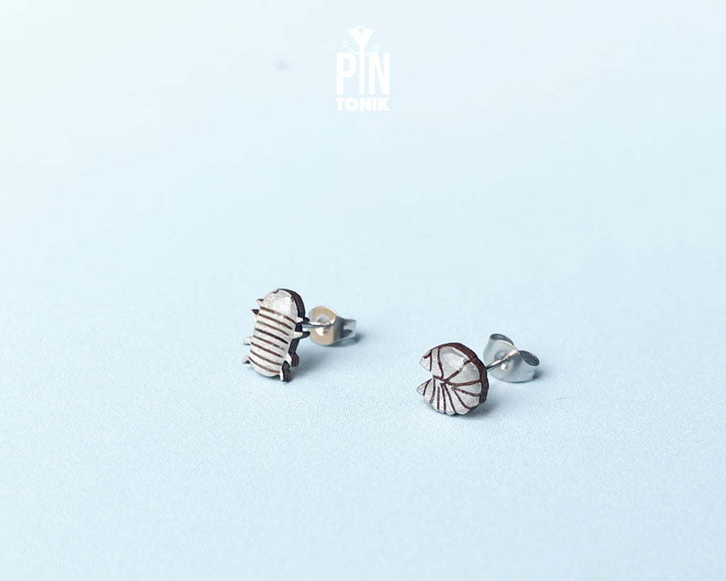 Handmade wooden mismatched rolly polly pill bug stud earrings showing one walking and one curled into a ball by PinTonik.