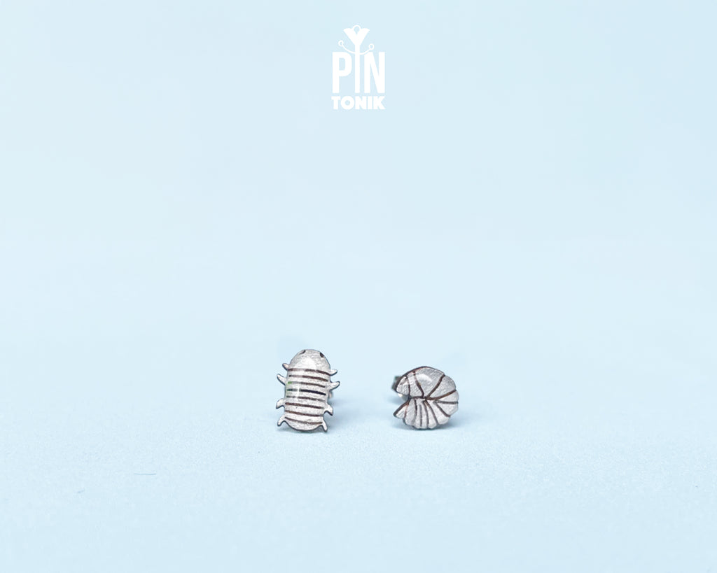 Handmade wooden mismatched rolly polly pill bug stud earrings showing one walking and one curled into a ball by PinTonik.