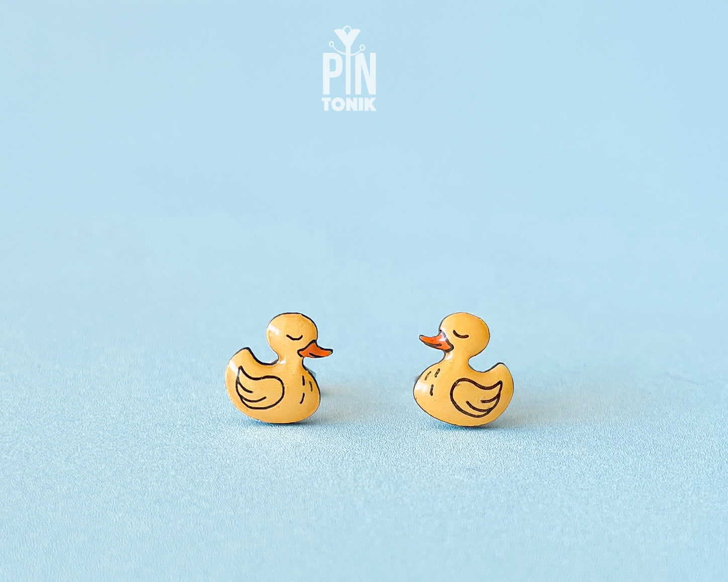 Pair of hand-painted yellow wooden duck stud earrings with a high-gloss resin finish