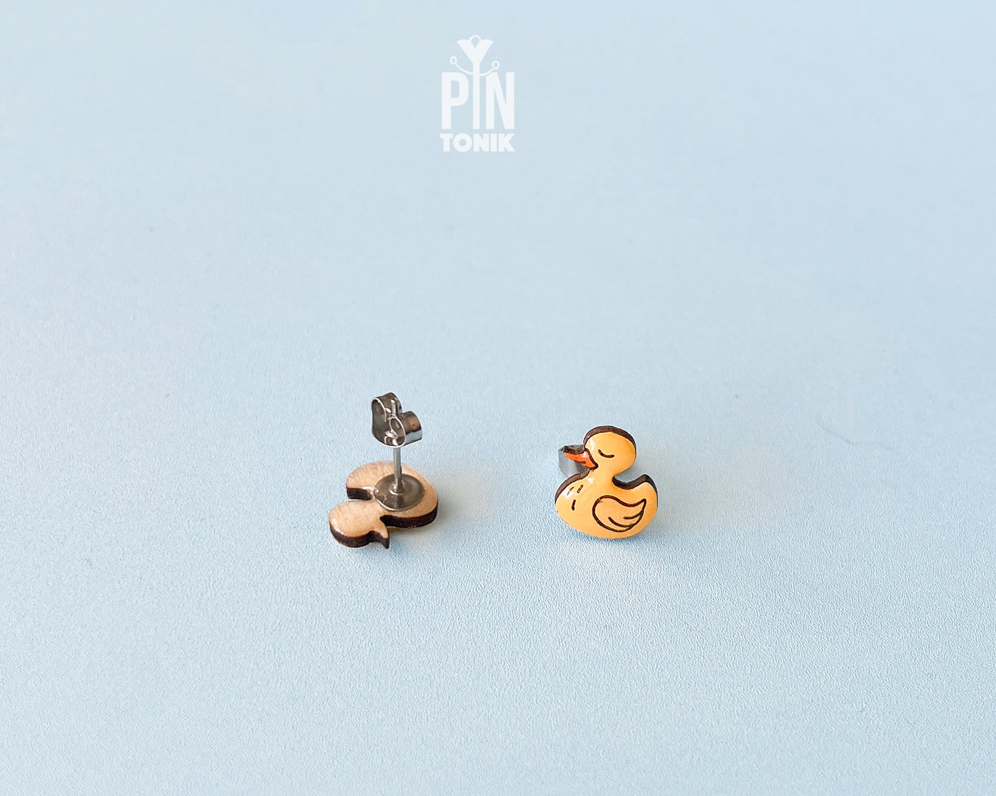 Pair of hand-painted yellow wooden duck stud earrings with a high-gloss resin finish