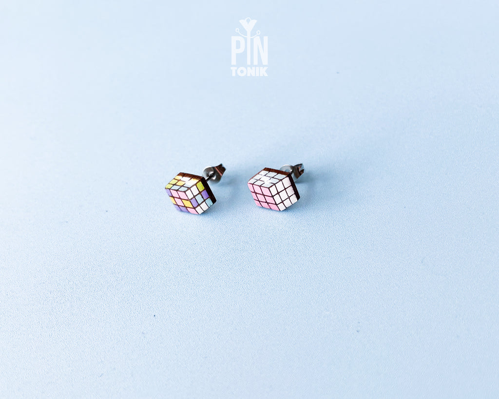 Handmade wooden magic puzzle cube stud earrings showing a three-dimensional perspective with colorful pastel grids by PinTonik