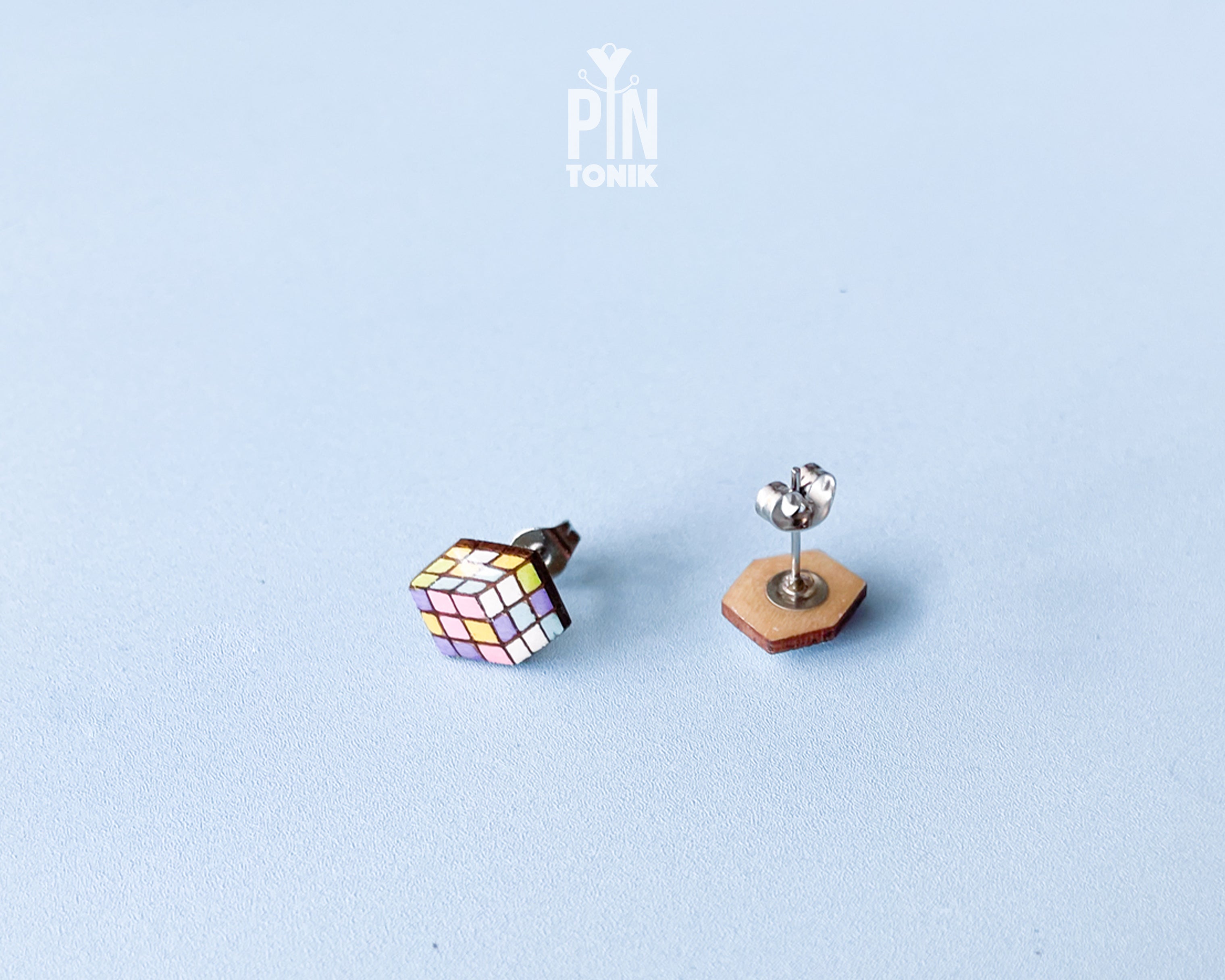 Handmade wooden Rubik's Cube stud earrings showing a three-dimensional perspective with colorful pastel grids by PinTonik