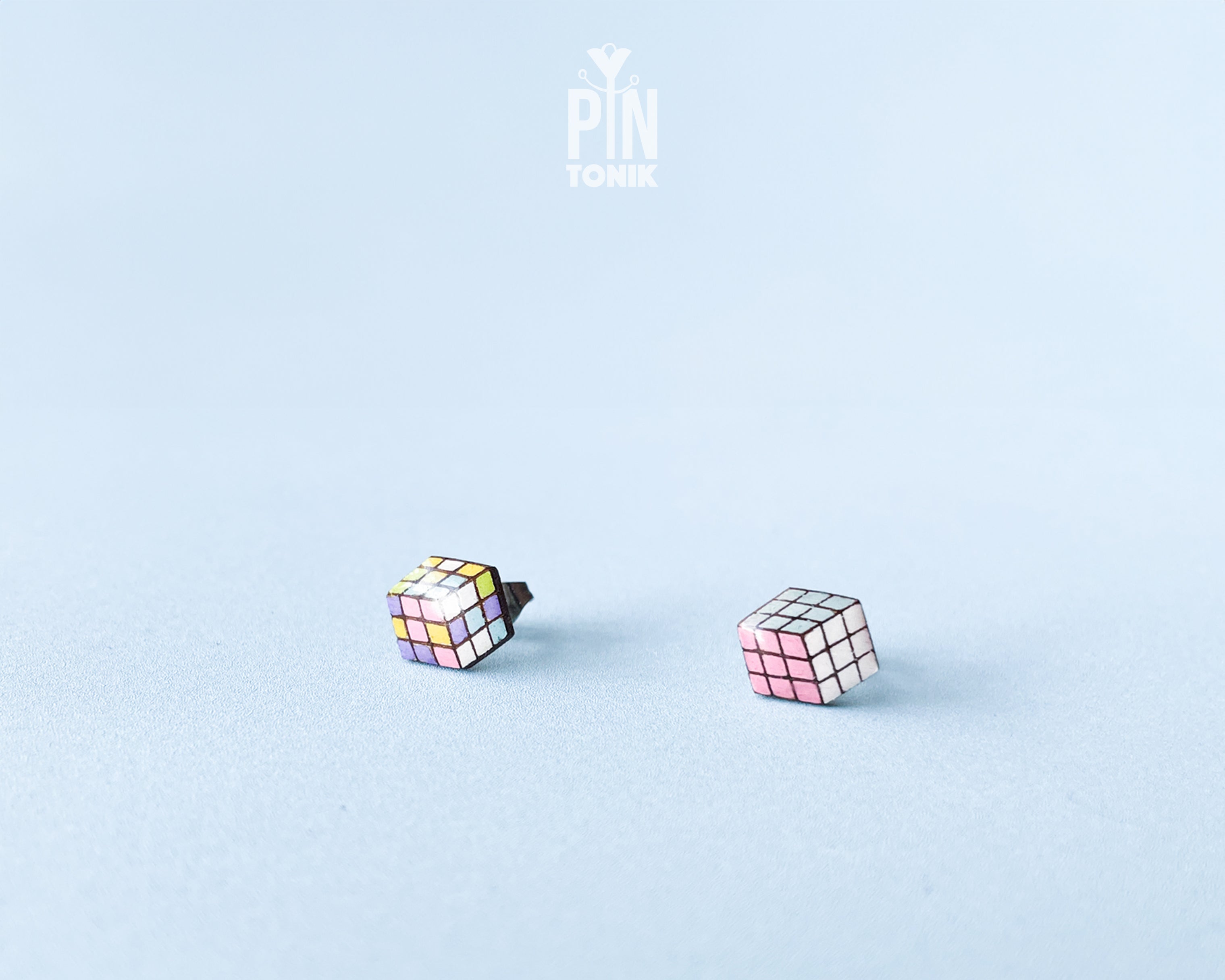 Handmade wooden magic Cube stud earrings showing a three-dimensional perspective with colorful pastel grids by PinTonik