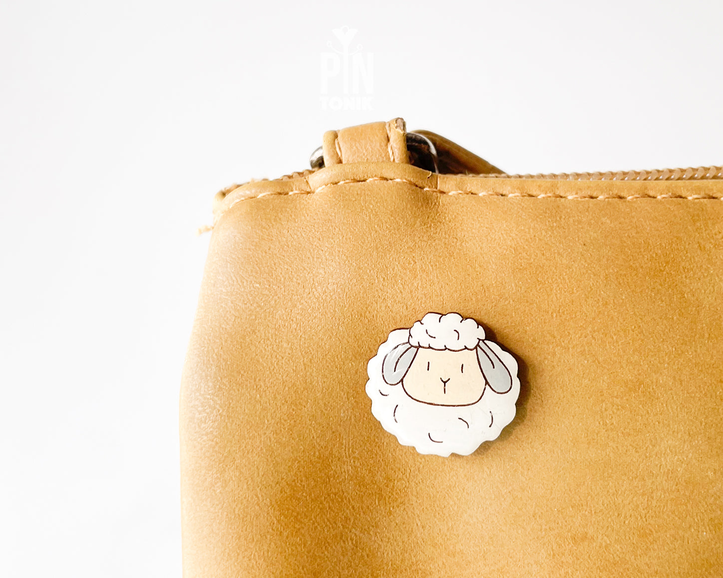 Hand-painted wooden sheep pin with a fluffy white wool design and a high-gloss resin finish
