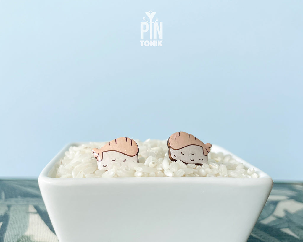 Handmade wooden salmon nigiri sushi stud earrings with a detailed pink salmon slice resting on white rice by PinTonik.