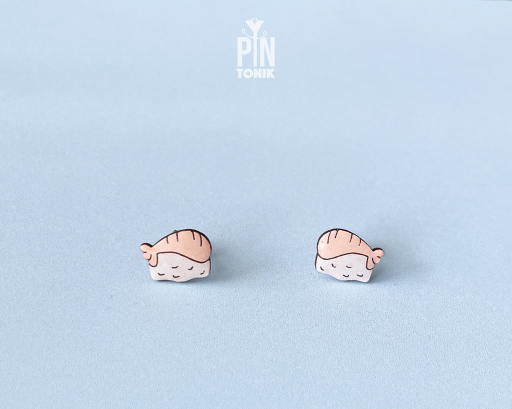 Handmade wooden salmon nigiri sushi stud earrings with a detailed pink salmon slice resting on white rice by PinTonik.