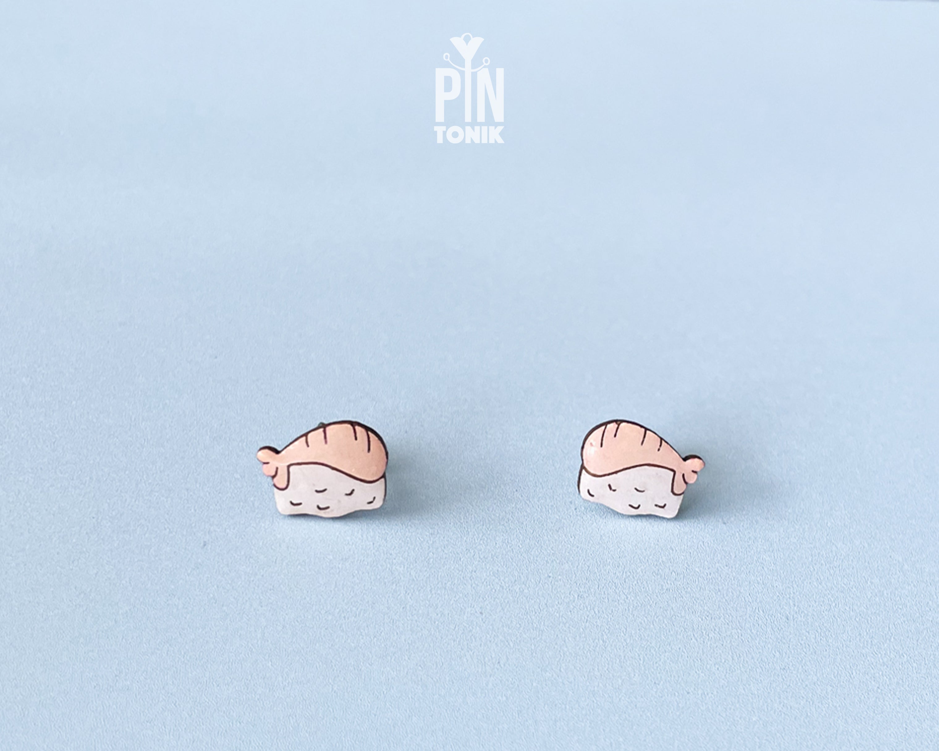 Handmade wooden salmon nigiri sushi stud earrings with a detailed pink salmon slice resting on white rice by PinTonik.