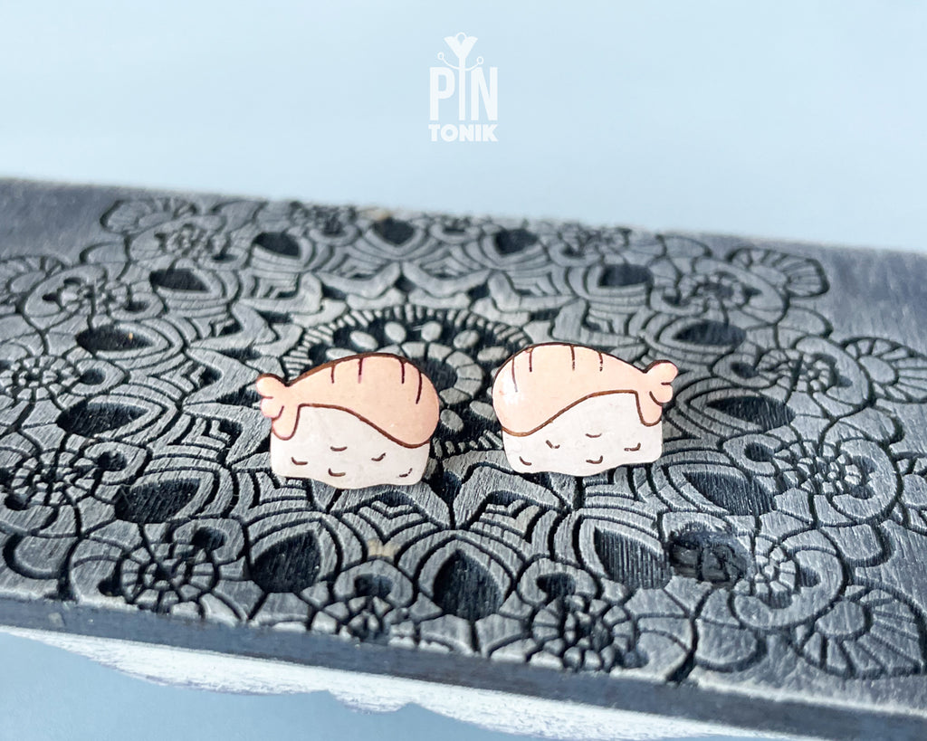 Handmade wooden salmon nigiri sushi stud earrings with a detailed pink salmon slice resting on white rice by PinTonik.