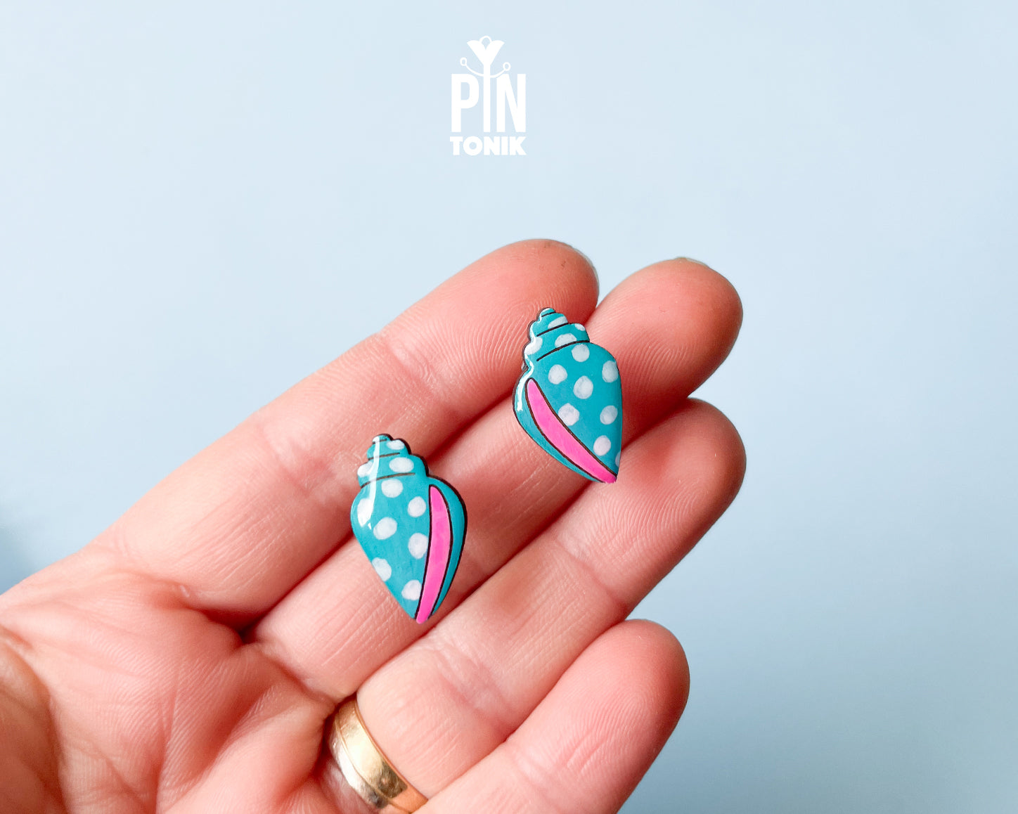 Handmade oversized wooden scallop shell stud earrings in pastel blue with bright pink accent lines by PinTonik.