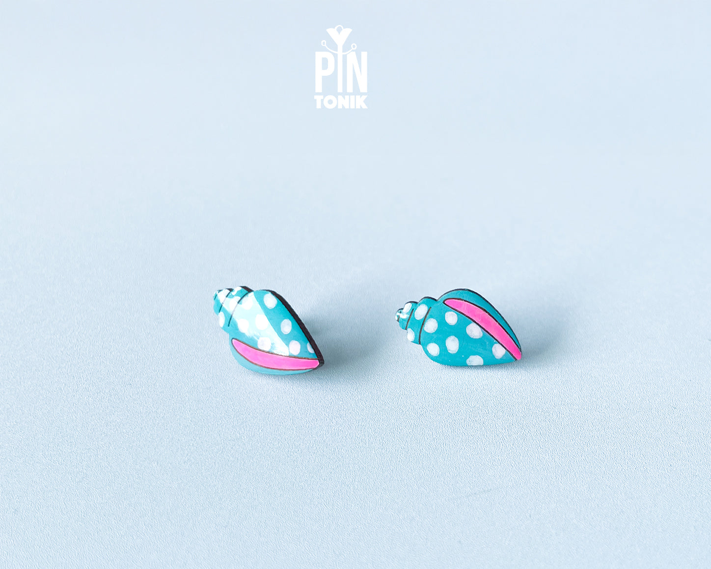 Handmade oversized wooden scallop shell stud earrings in pastel blue with bright pink accent lines by PinTonik.