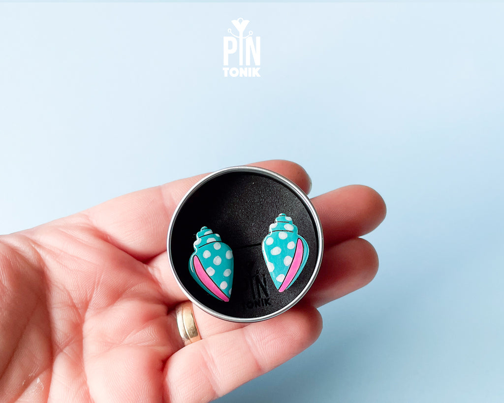 Handmade oversized wooden scallop shell stud earrings in pastel blue with bright pink accent lines by PinTonik.