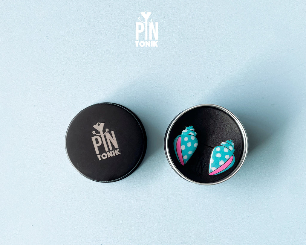 Handmade oversized wooden scallop shell stud earrings in pastel blue with bright pink accent lines by PinTonik.