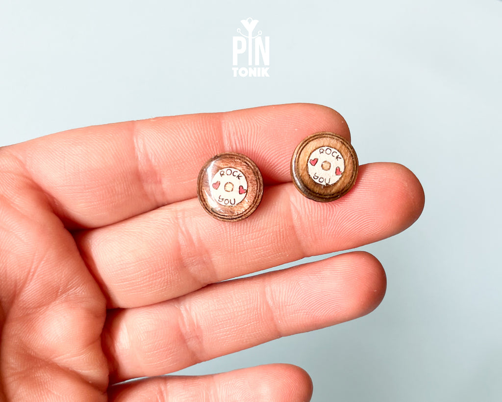Handmade wooden vinyl record stud earrings in vintage brown with a center label reading 'ROCK ❤️ YOU' by PinTonik.